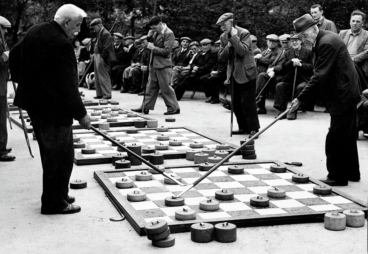1946:Men taking part in a game of draughts at the giant sets in the gardens which proved so popular.
