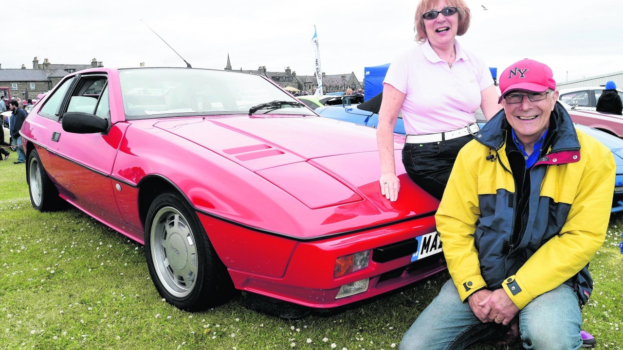 JOHN AND JACQUELINE MCBEATH FROM NEWPORT ON TAY WITH THEIR  1986 LOTUS EXCEL