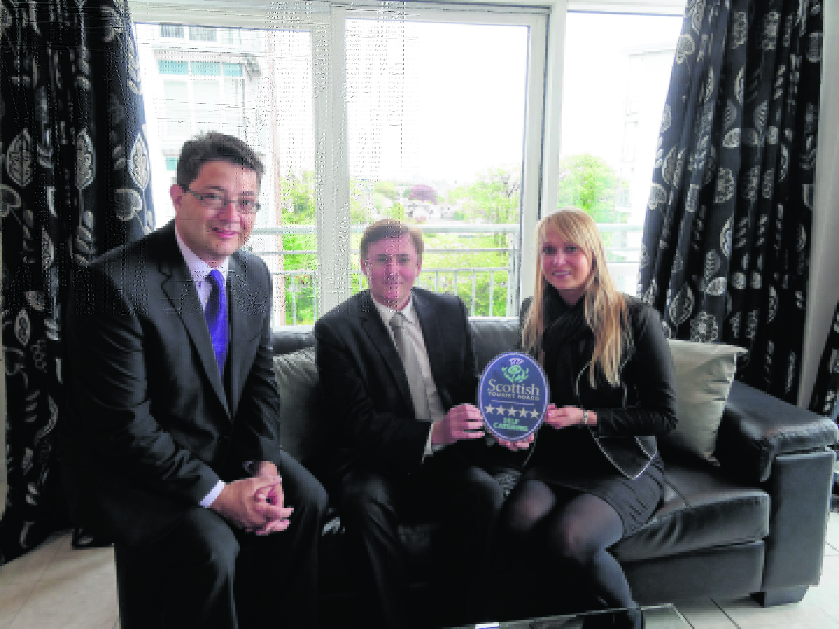 Philip Smith, VisitScotland Regional Director, with Duncan Kerr and Rita Valiukaite, from AM-PM Leasing & Property Management
