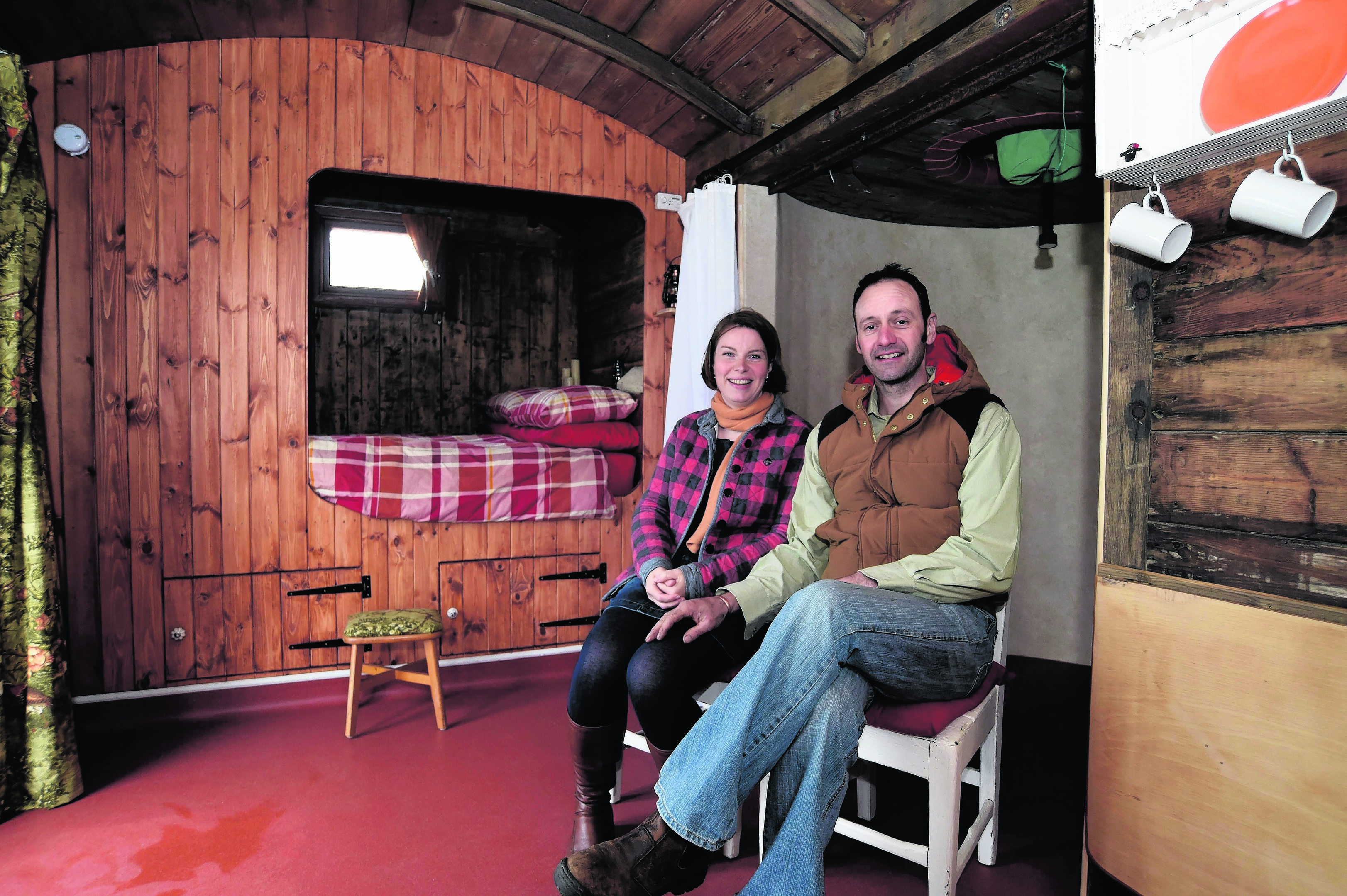 MATTHEW AND CAROLE SHORT IN THE 1930'S FREIGHT TRAIN CARRIAGE THEY CONVERTED TO A HOLIDAY HOME AT HIGH SEAS HOBBITS, ROSEHEARTY.