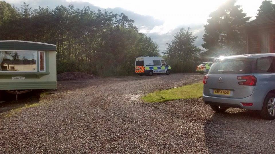 The police vehicles at the Deeside Holiday Park last night