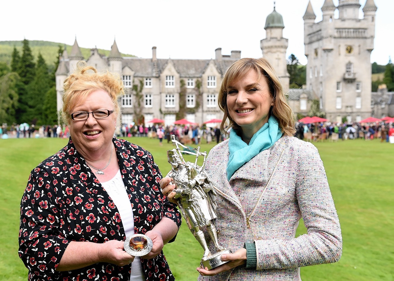 Balmoral housekeeper Sheena Stuart and presenter Fiona Bruce with Prince Albert brooch and William Ross statue. Picture by Kami Thomson