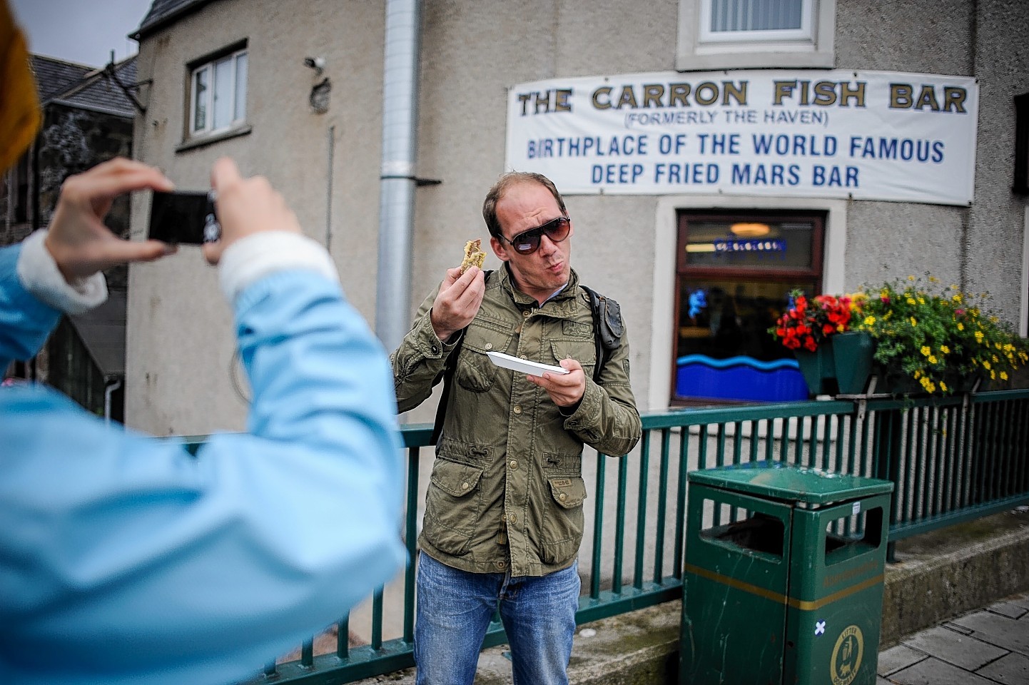 Tourist Dominik Wiltsehnig, 29, from Austria has his photo taken outside the Carron Fish Bar in Stonehaven,