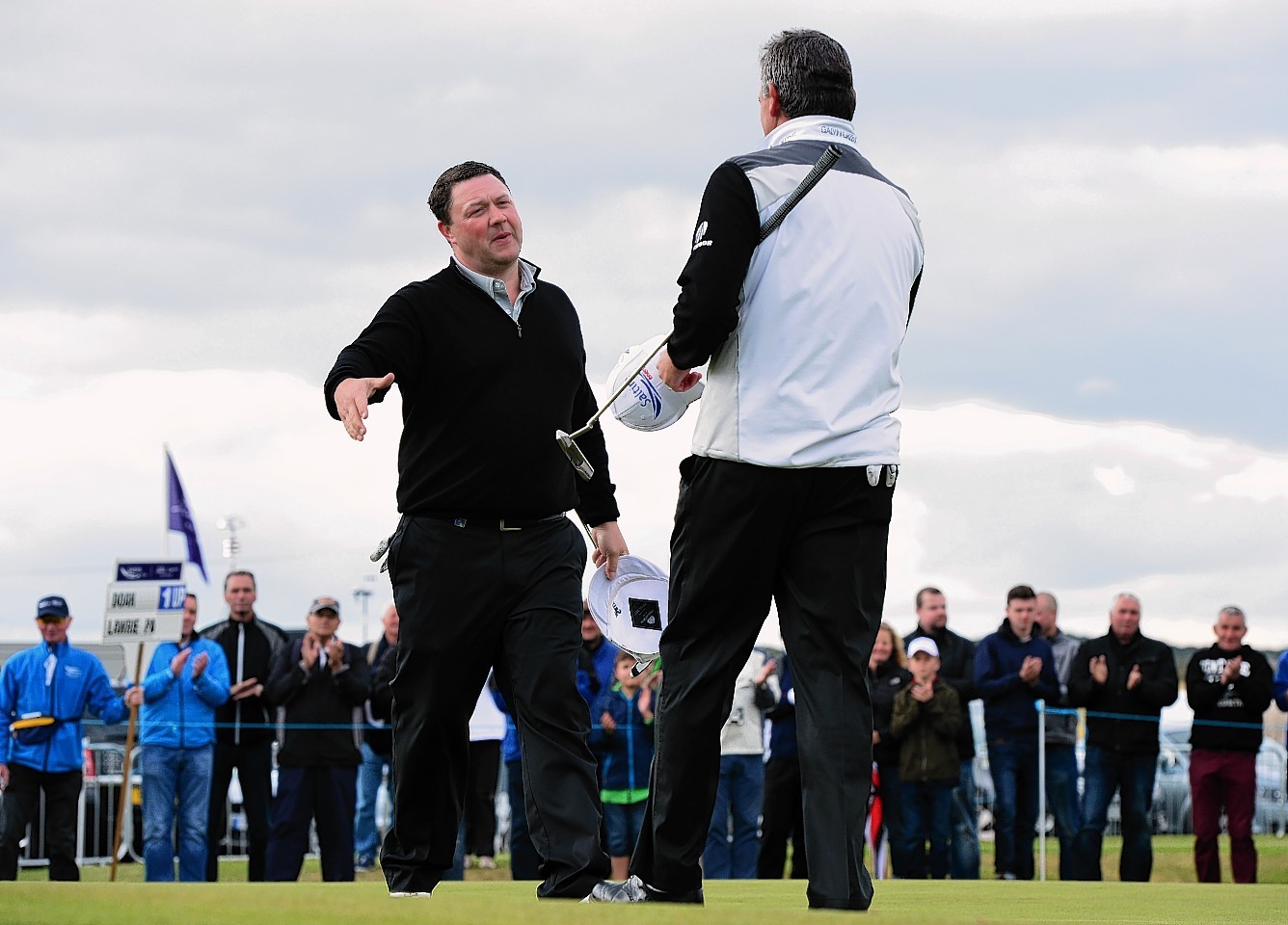 Doak and Lawrie on the 18th green at the end of their round