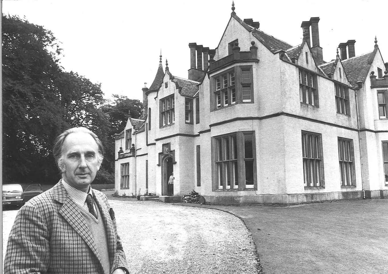 The Laird of Auchmacoy, David Buchan, in front of the imposting turretted 19th century mansion house in its spacious grounds on August 8, 1980.