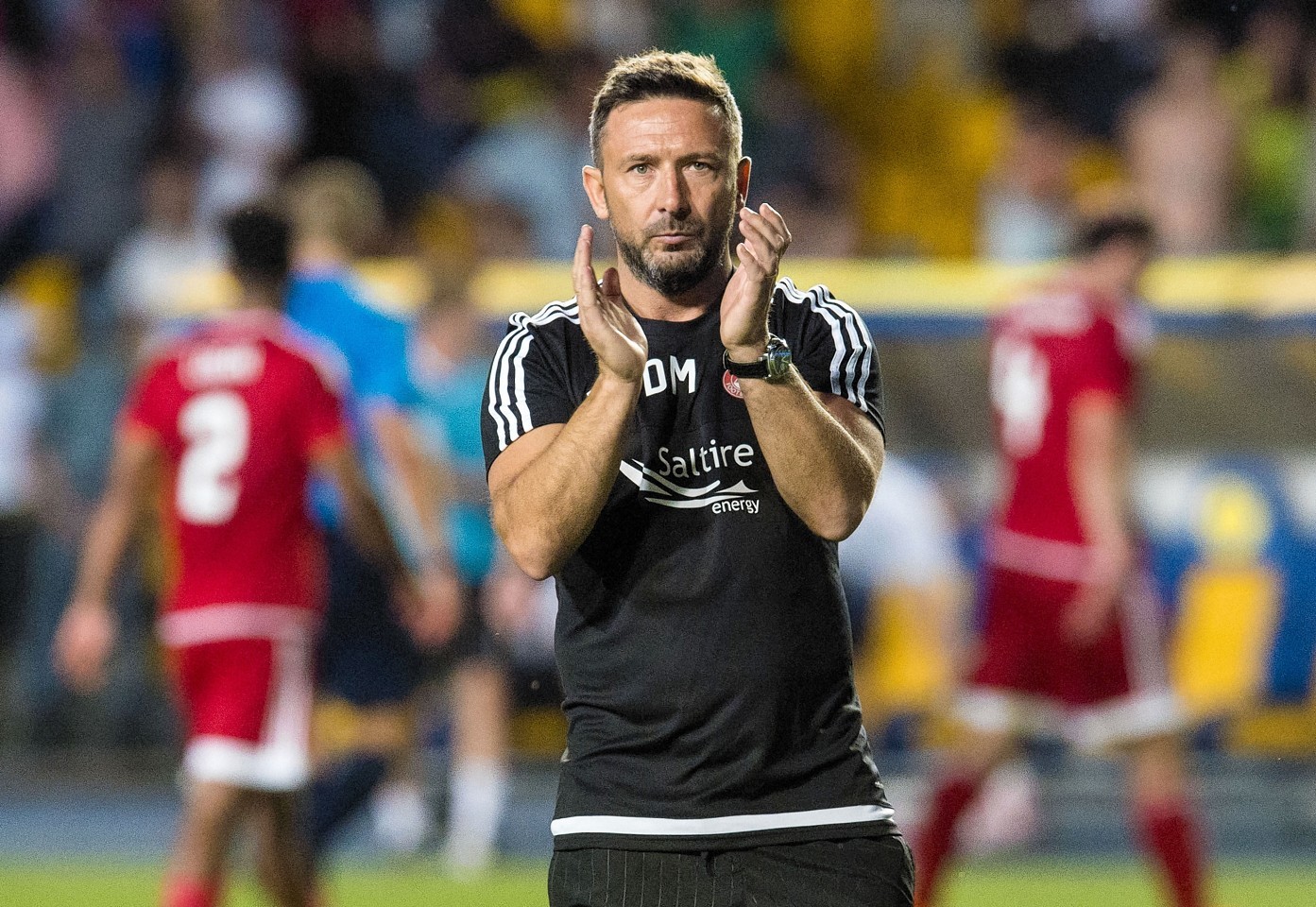 McInnes applauds the travelling Dons fans at full time
