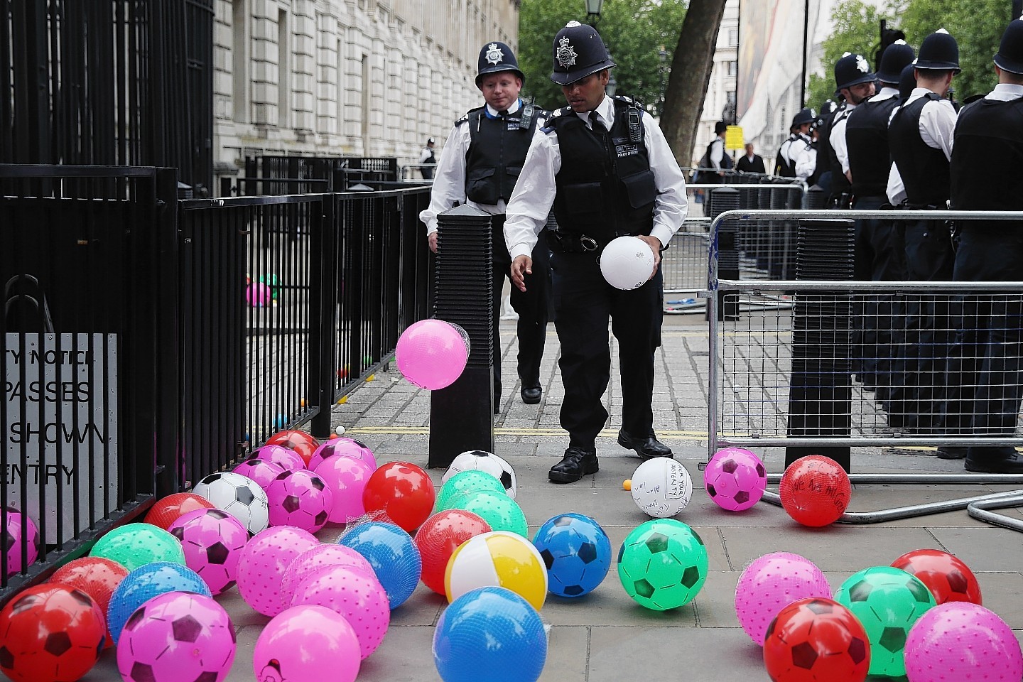 Anti austerity protesters throw balls towards Downing Street