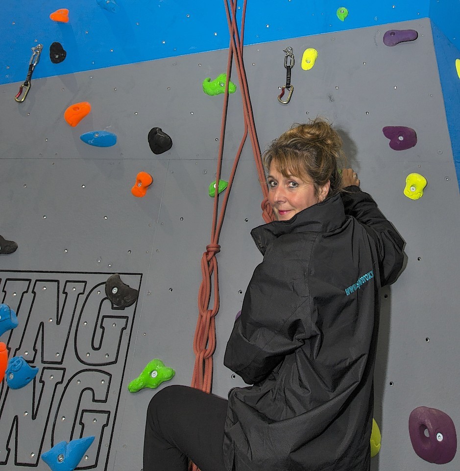 Owner Jo Maunder scales the new climbing wall