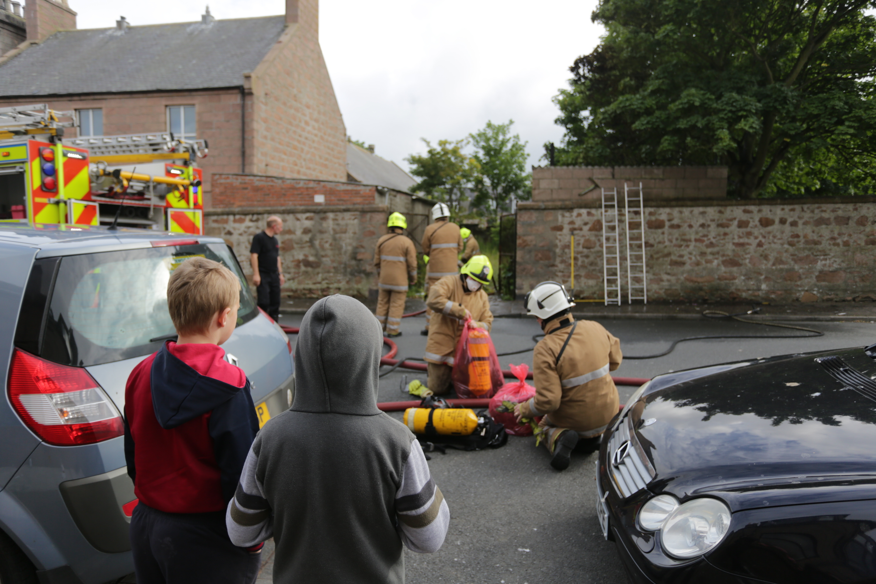 Youngsters watch on as firemen work at the fire on St Peter Street