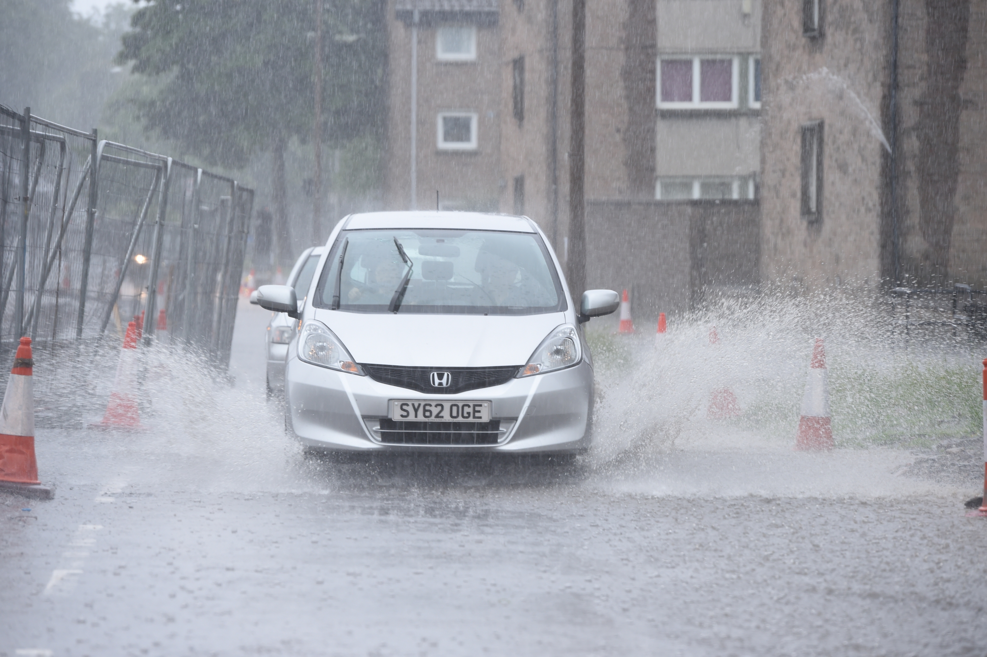 Cars battle their way through the city floods 