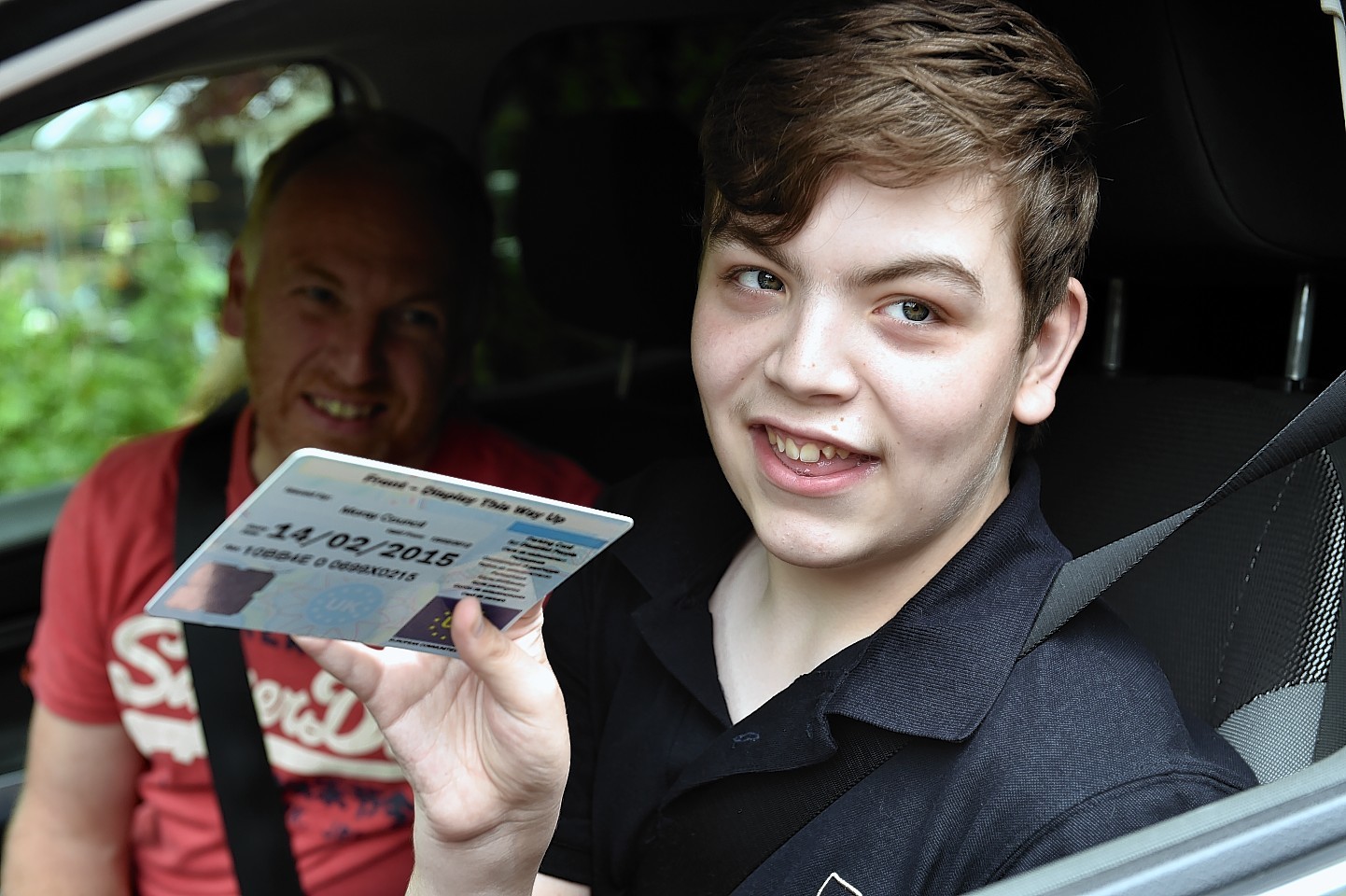 Glyn Morris and his son Gregor, with his expired blue badge.