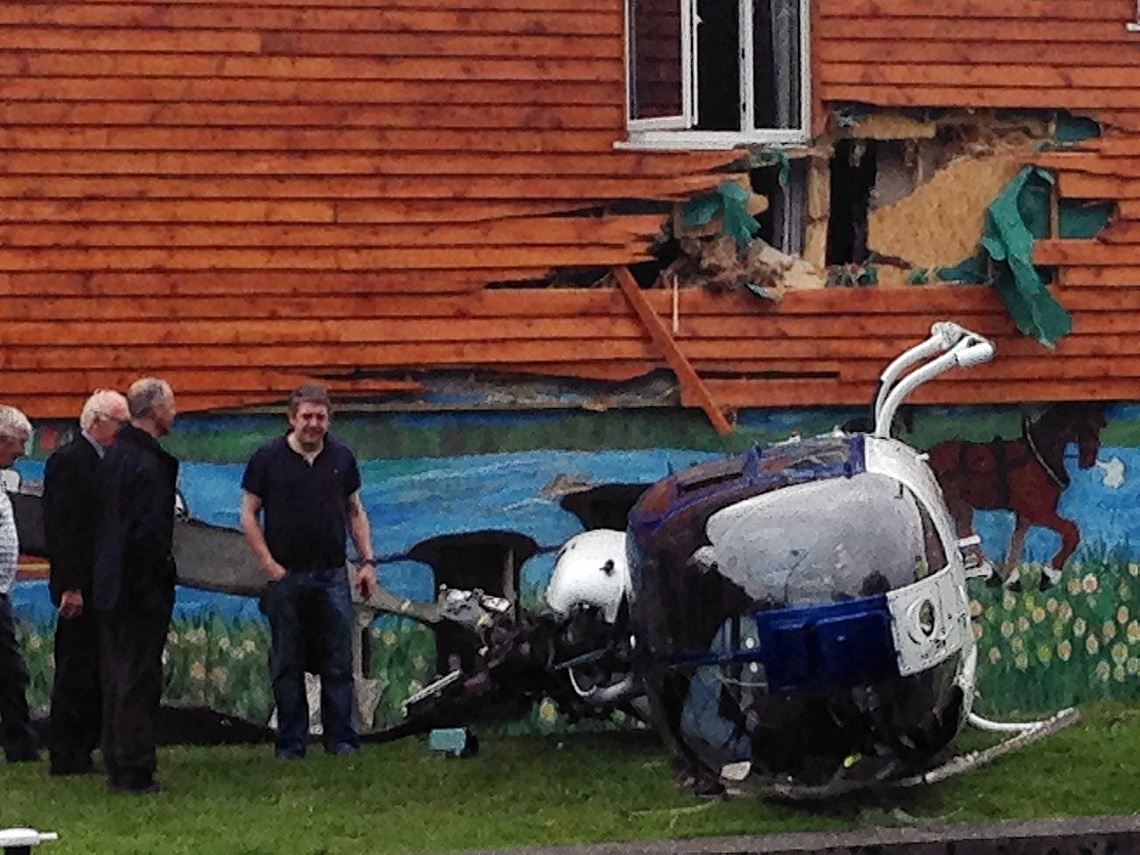 The scene across the Royal Canal of the wreckage of a helicopter crash and damage to the rear of the Rustic Inn, Abbeyshrule, Co Longford. PRESS ASSOCIATION Photo. Picture date: Thursday July 16, 2015. The publican and his wife, Teddy and Betty McGoey, narrowly escaped the force of a blast when a helicopter crashed into their canal side pub.