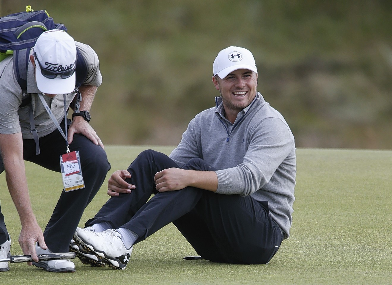 Jordan Spieth misses a putt but manages to see the funny side as he collapses to the ground