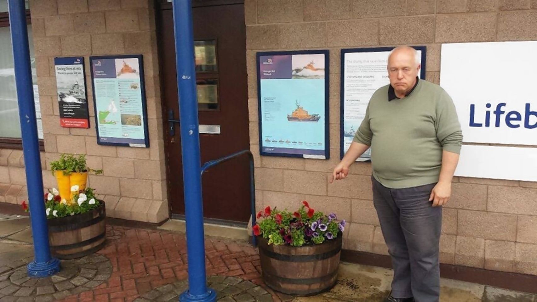 Kevin Dent outside the station with the yellow wellies which were stolen