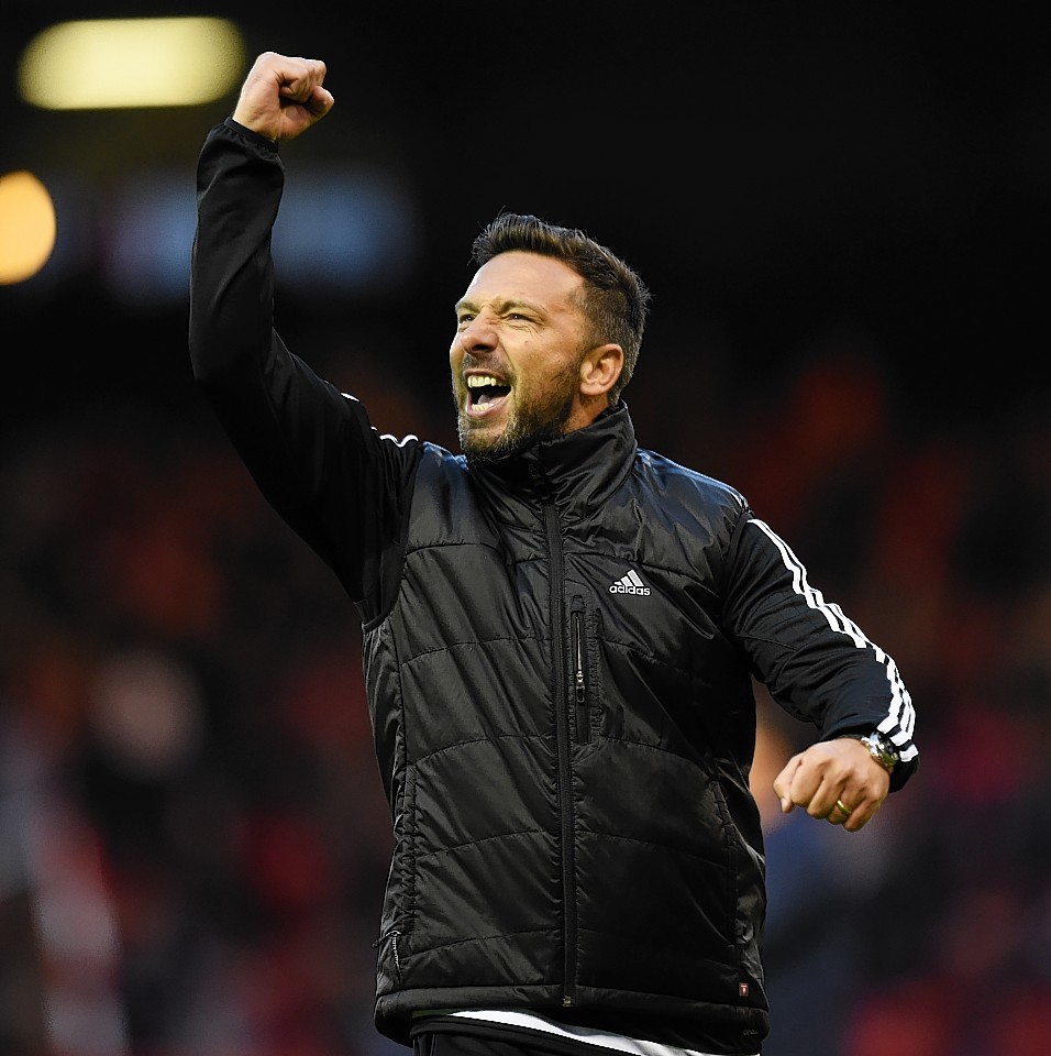 McInnes salutes the Pittodrie faithful after watching his team qualify on away goals