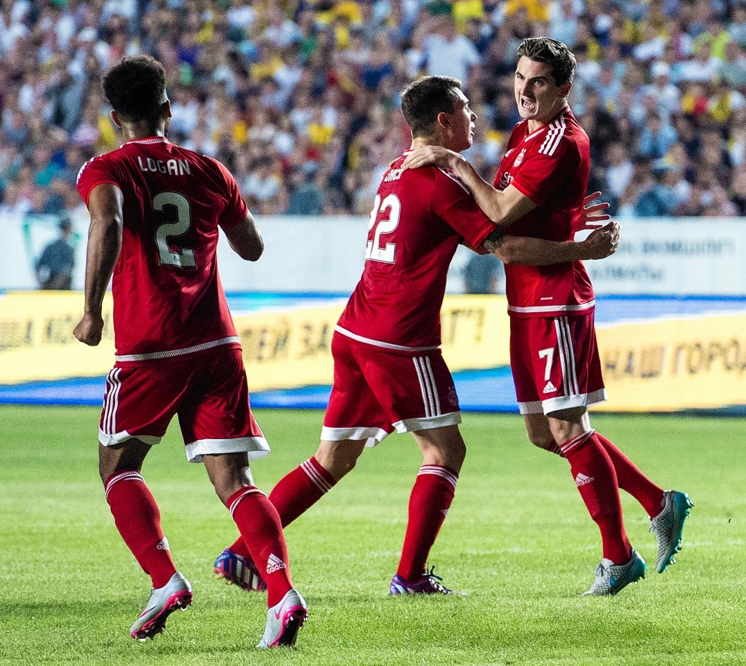 Ryan Jack and Shay Logan celebrate with Kenny McLean after the midfielder netted for the Dons