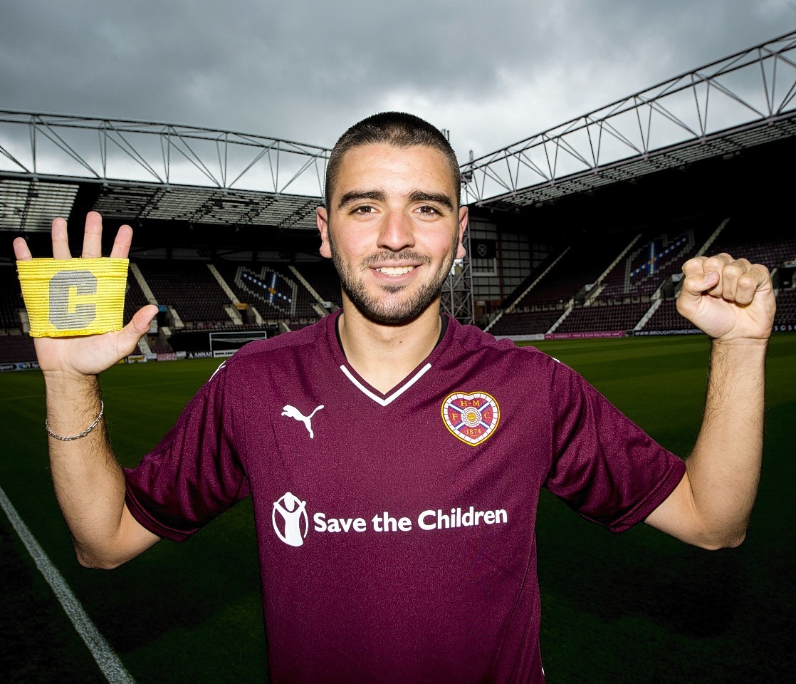 Alim Ozturk is all smiles after being unveiled as the new captain of Hearts.