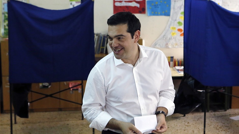 Greece's Prime Minister Alexis Tsipras casts his vote at a polling station in Athens (AP)