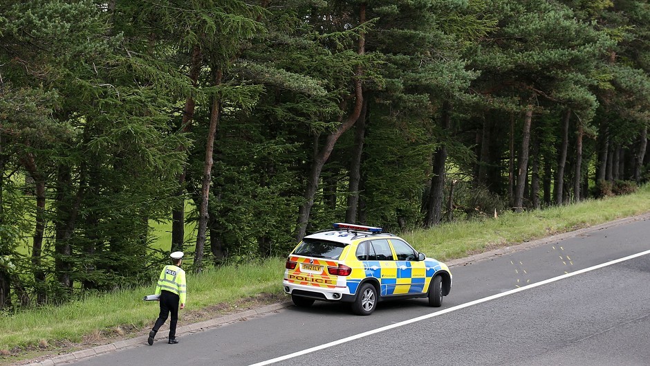 A police car near to the site of the crash on junction 9 of the M9 which resulted in the deaths of John Yuill and Lamara Bell