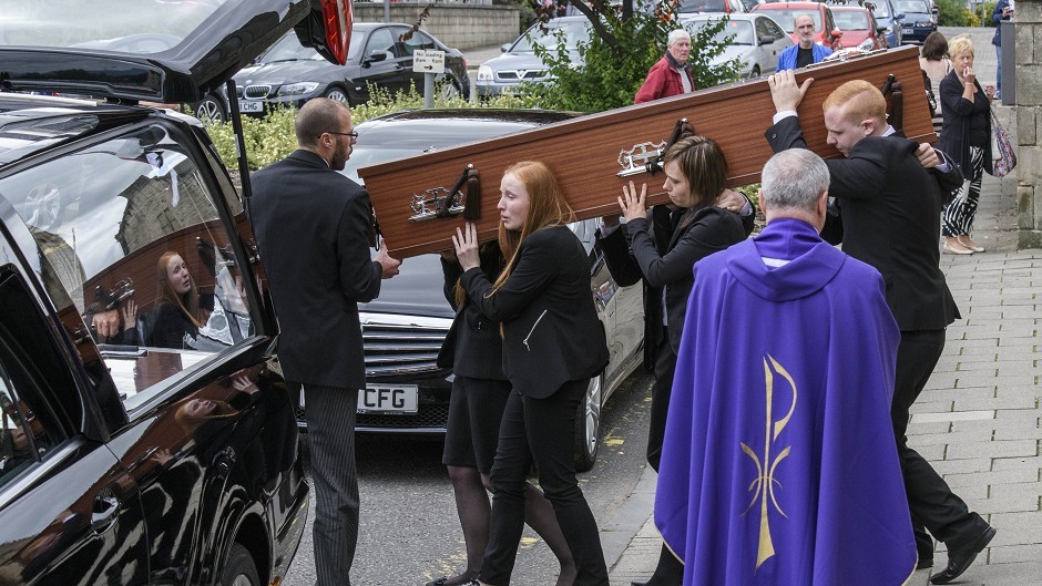 The coffin of John Yuill is carried to the hearse following his funeral at St Francis Xavier's RC Church in Falkirk