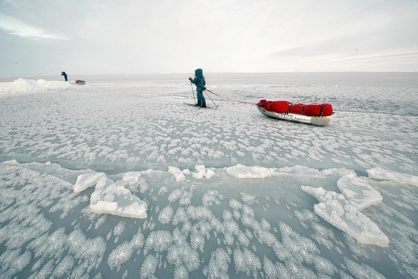 Charlie Paton and a team mate pulling sledge on thin ice in the North Pole.