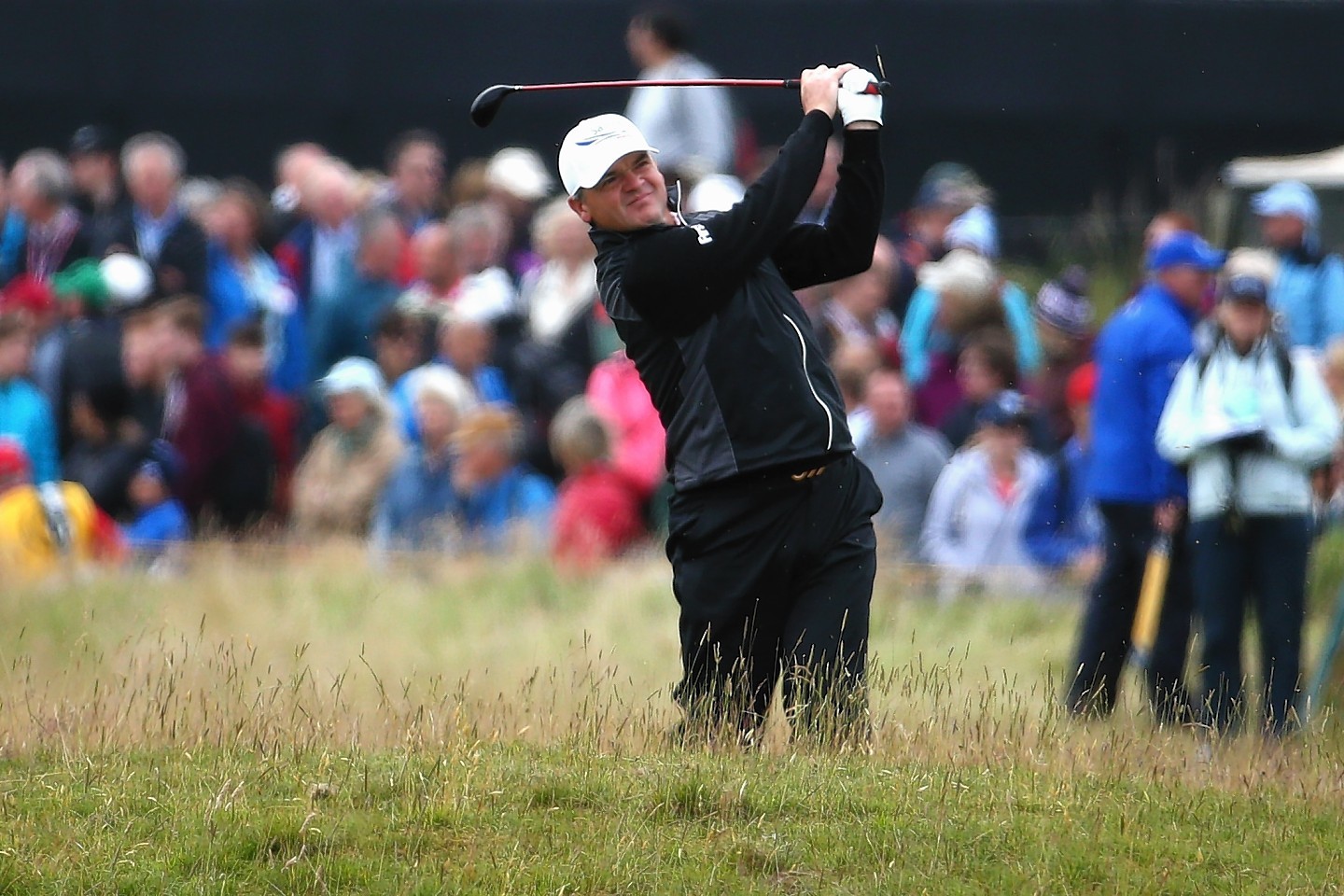 Paul Lawrie of Scotland plays his second shot on the 4th hole during the first round of the 144th Open Championship at The Old Course