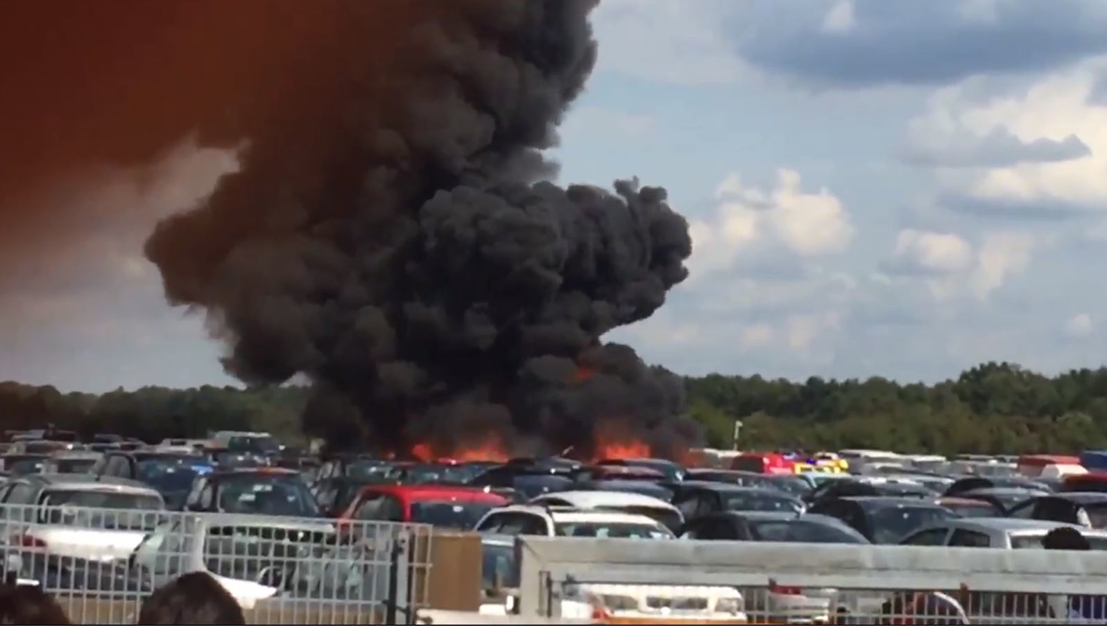 Thick black smoke is blown across the sky following the crash