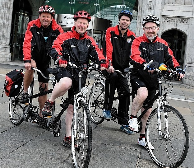 Lord Provost George Adam set off cyclists from the Aberdeen YMCA who are to cycle on tandems to Regensburg in Germany as part of the 60th anniversary of the partnership between the two cities.