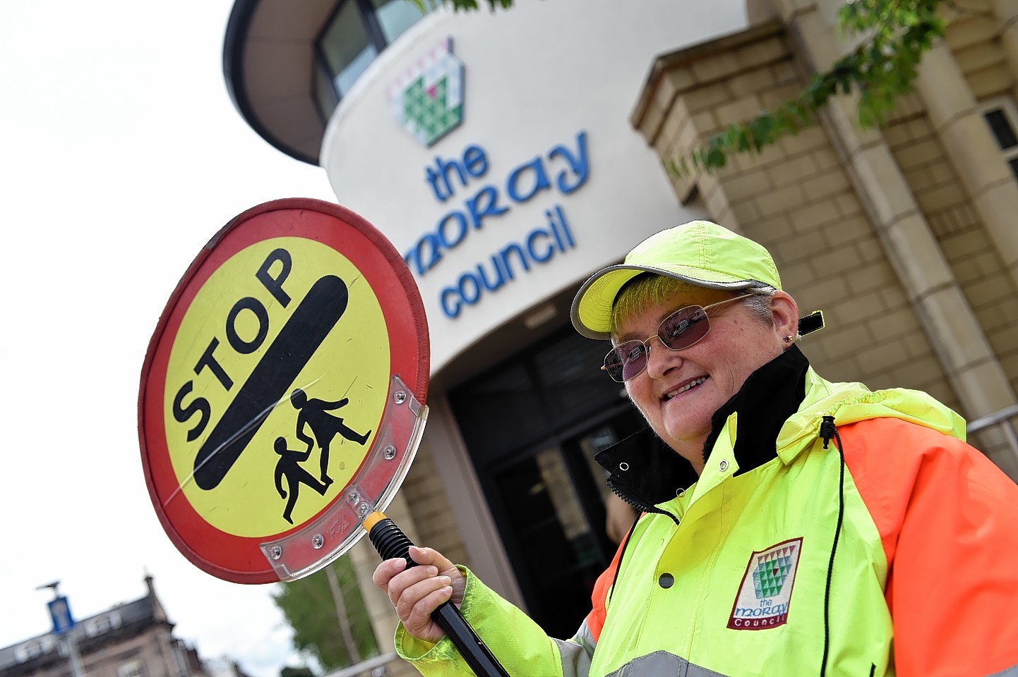 School crossing patroller in front of Moray Council building