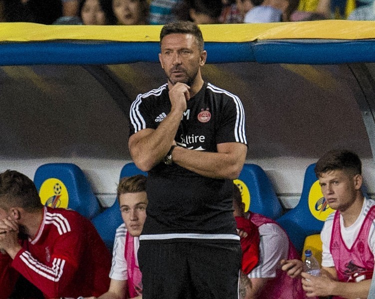 Aberdeen manager Derek McInnes in the dugout in Almaty. 