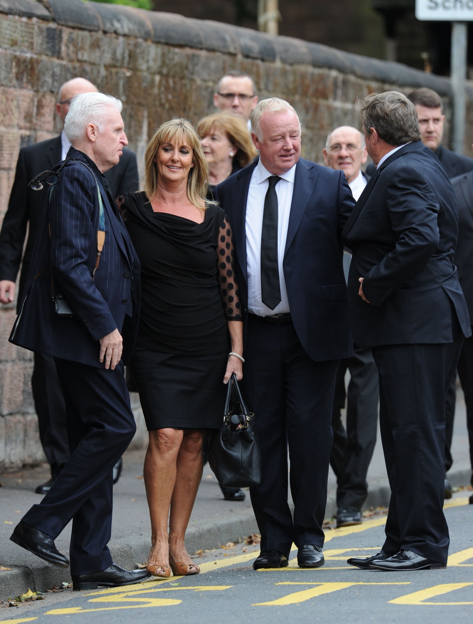 Les Dennis  (second right) arrives with other mourners 
