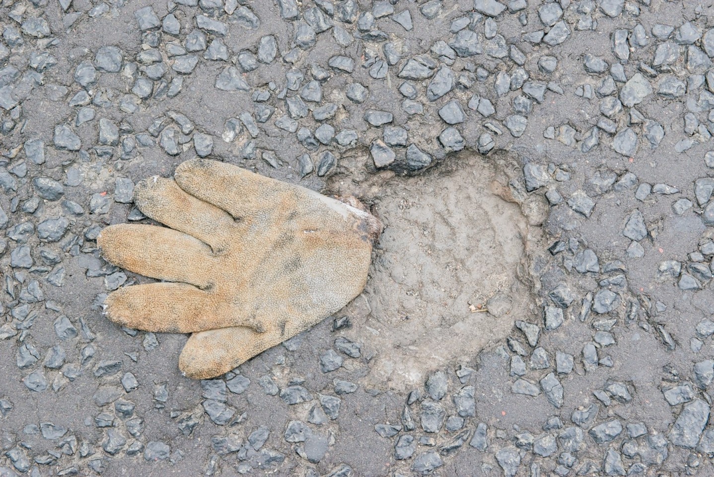 A pothole caused by workmans Glove after the road was closed for nearly a month for resurfacing in the Corstorphine area of Edinburgh