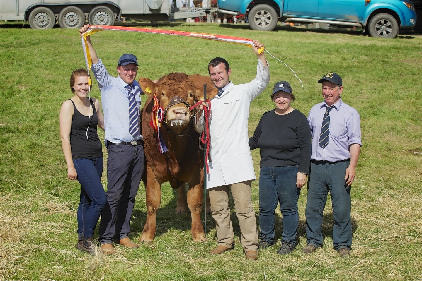 The Irvine family celebrates with the champion bull