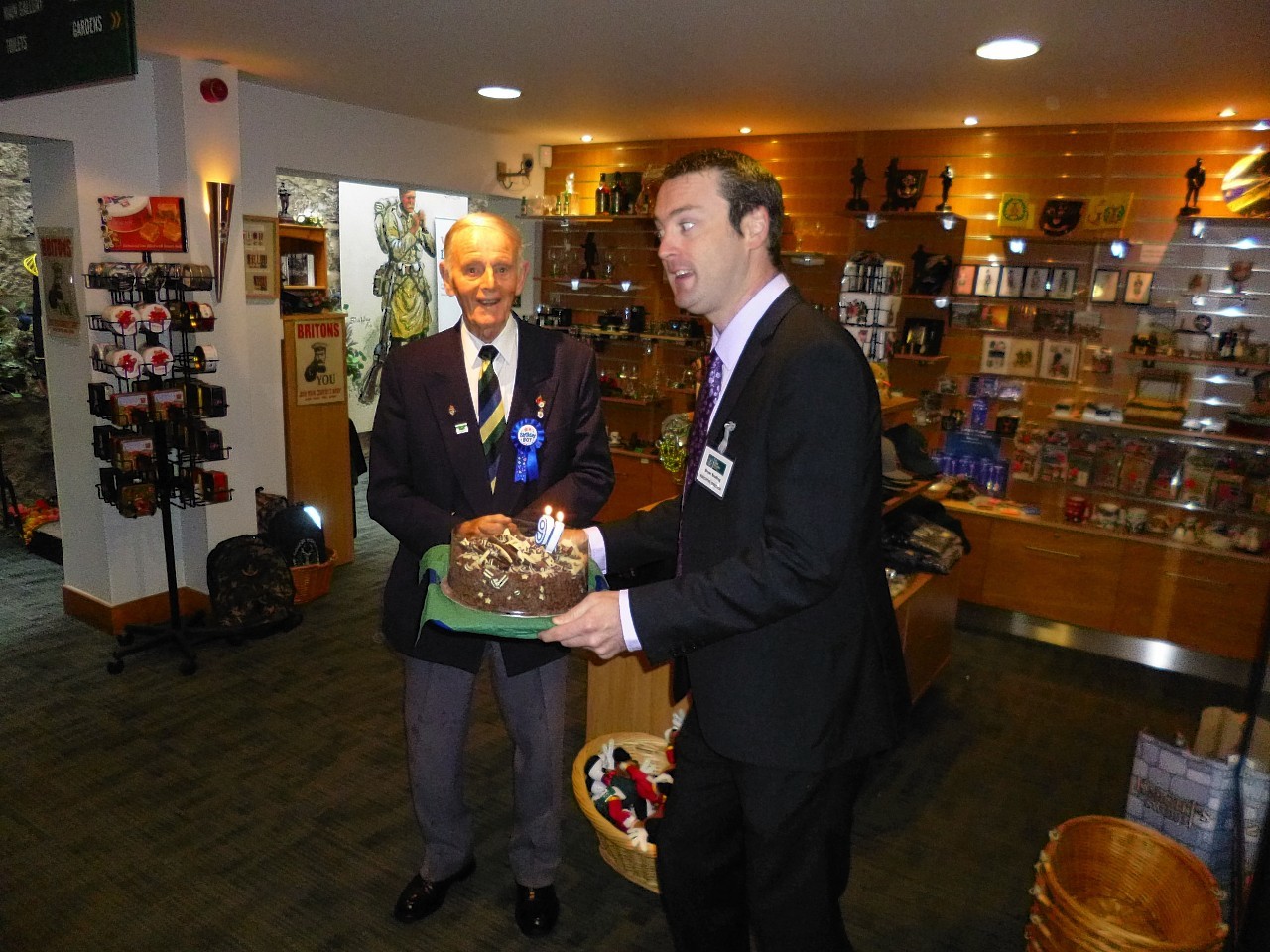 Jim Glennie receives his 90th birthday cake from museum executive director, Bryan Snelling.