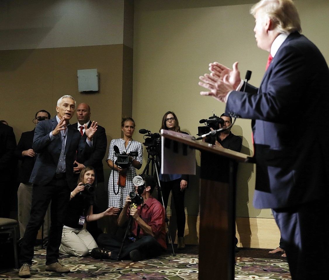 Miami-based Univision anchor Jorge Ramos, left, asks Republican presidential candidate Donald Trump a question about his immigration proposal during a news conference,