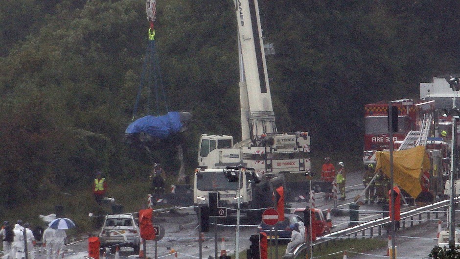 A giant crane is used to remove wreckage of the plane on the A27 at Shoreham in West Sussex