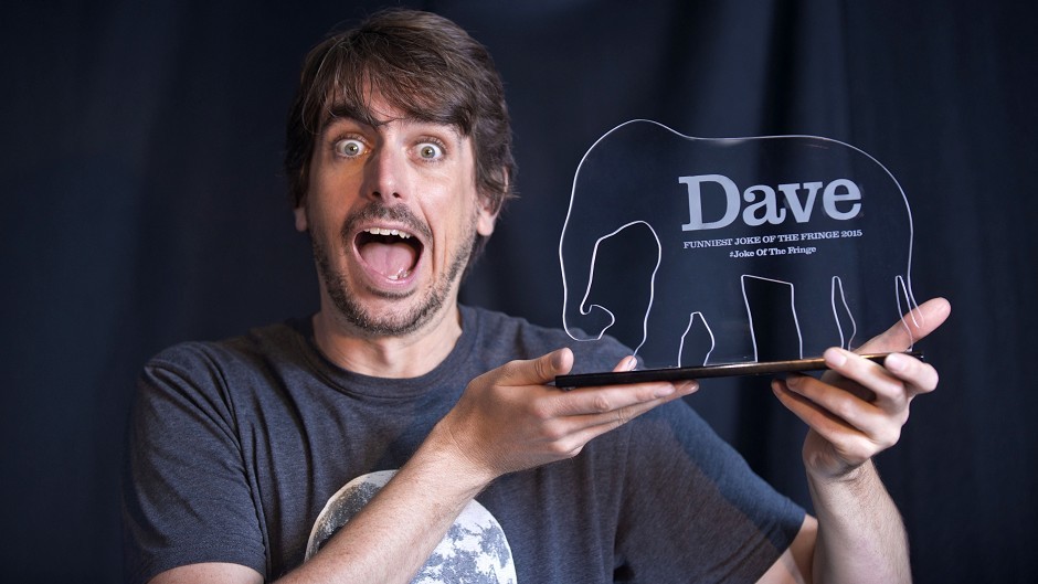 Comedian Darren Walsh shows off his prize for winning the Dave Funniest Joke of the Fringe 2015 (UKTV Dave/Martina Salvi/PA)