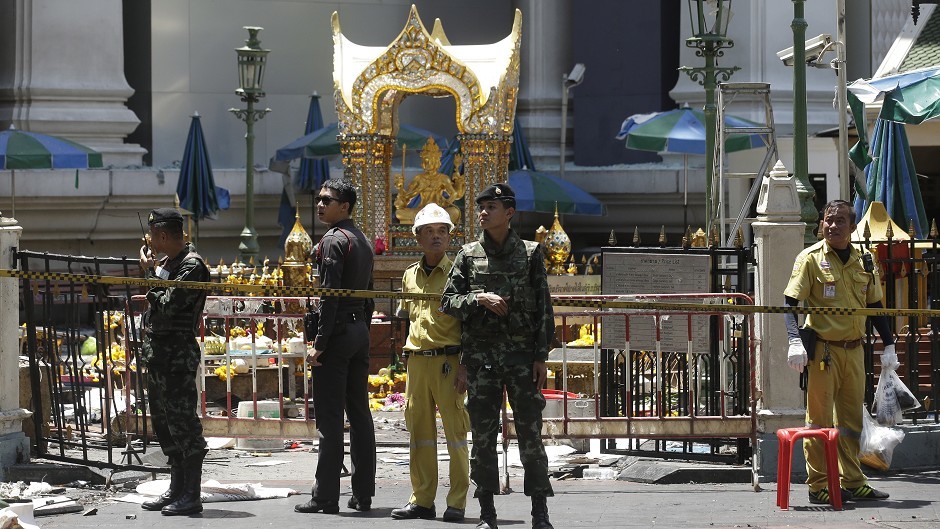 Police, soldiers and other officials at the Erawan Shrine the day after the explosion