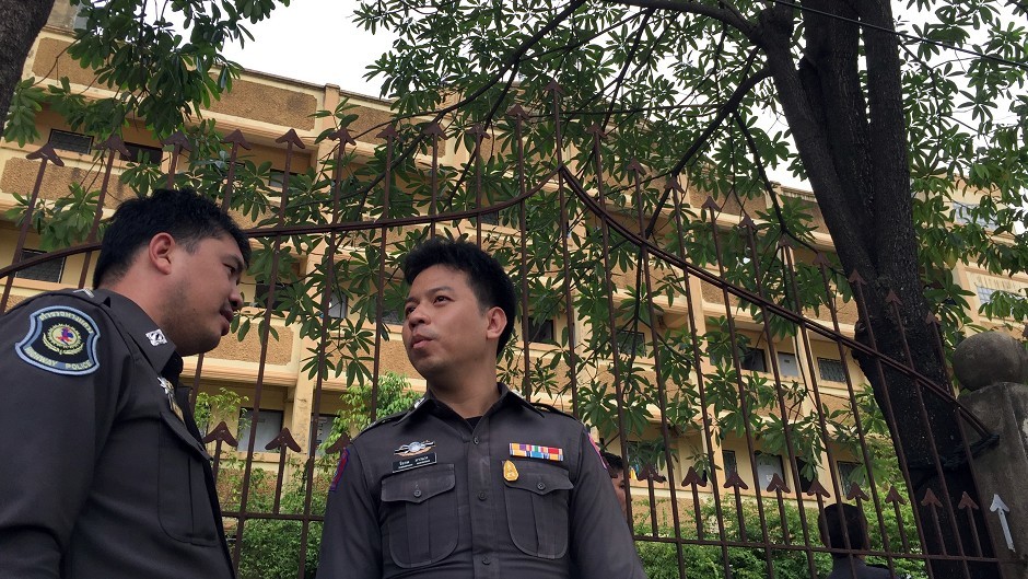Thai police stand outside an apartment building in Nong Jok on the outskirts of Bangkok in which a bombing suspect was arrested (AP)