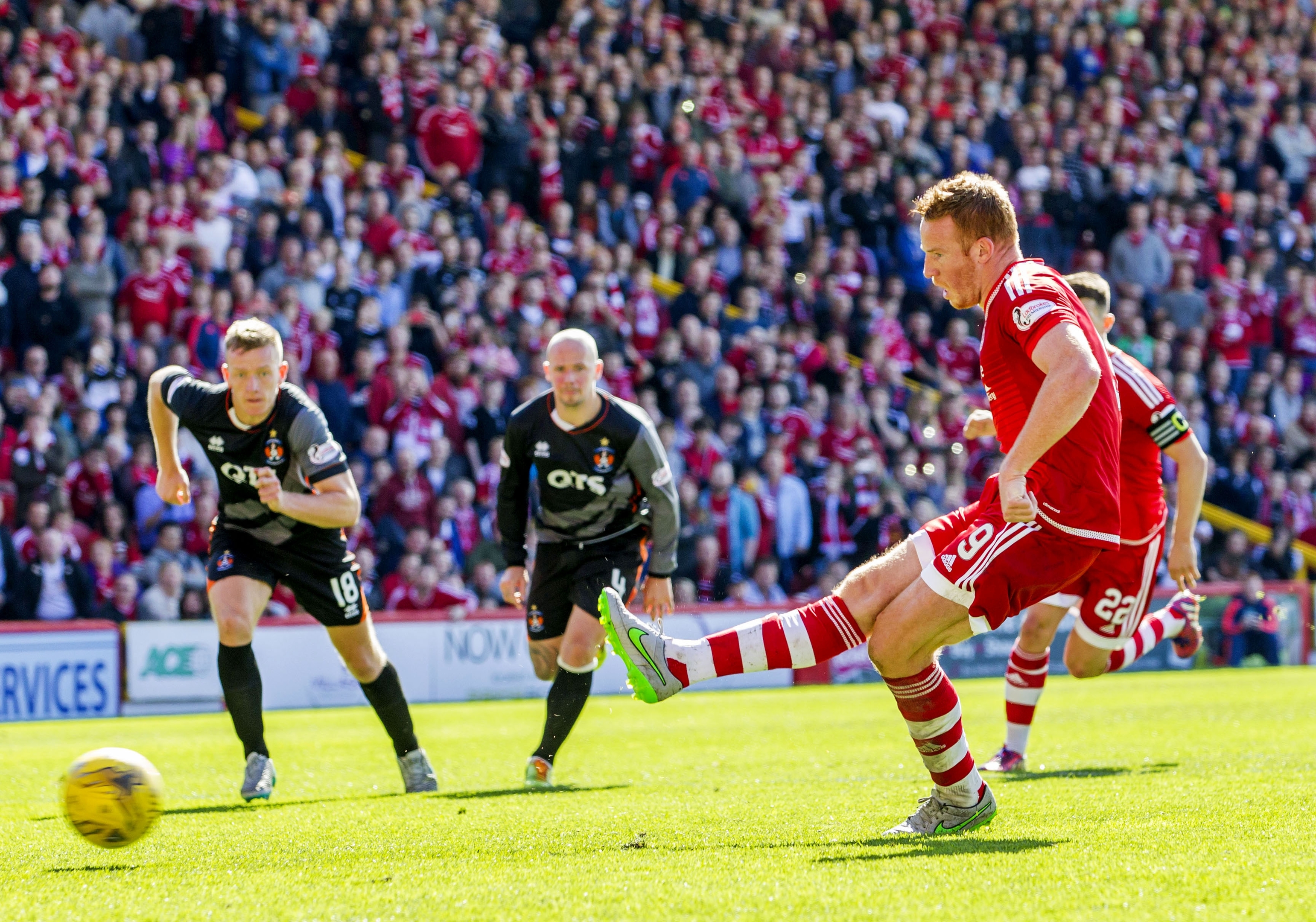 Adam Rooney scores from the spot for the Dons