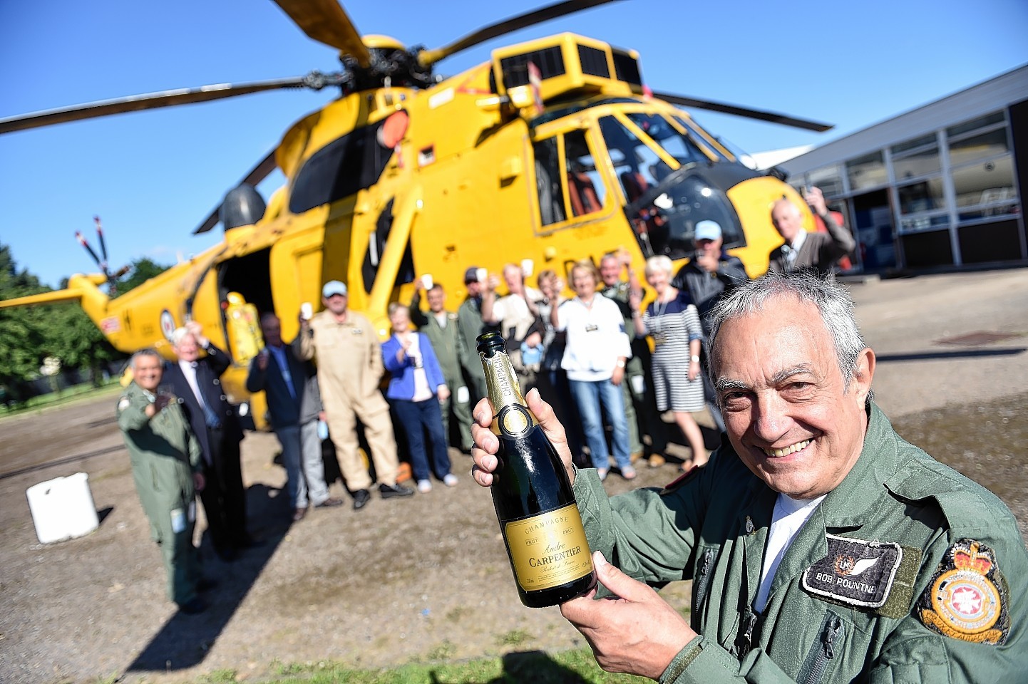 Morayvia director, Bob Pountney, breaks out the champagne to celebrate the Sea King being installed at their headquarters in Kinloss.
Picture by Gordon Lennox