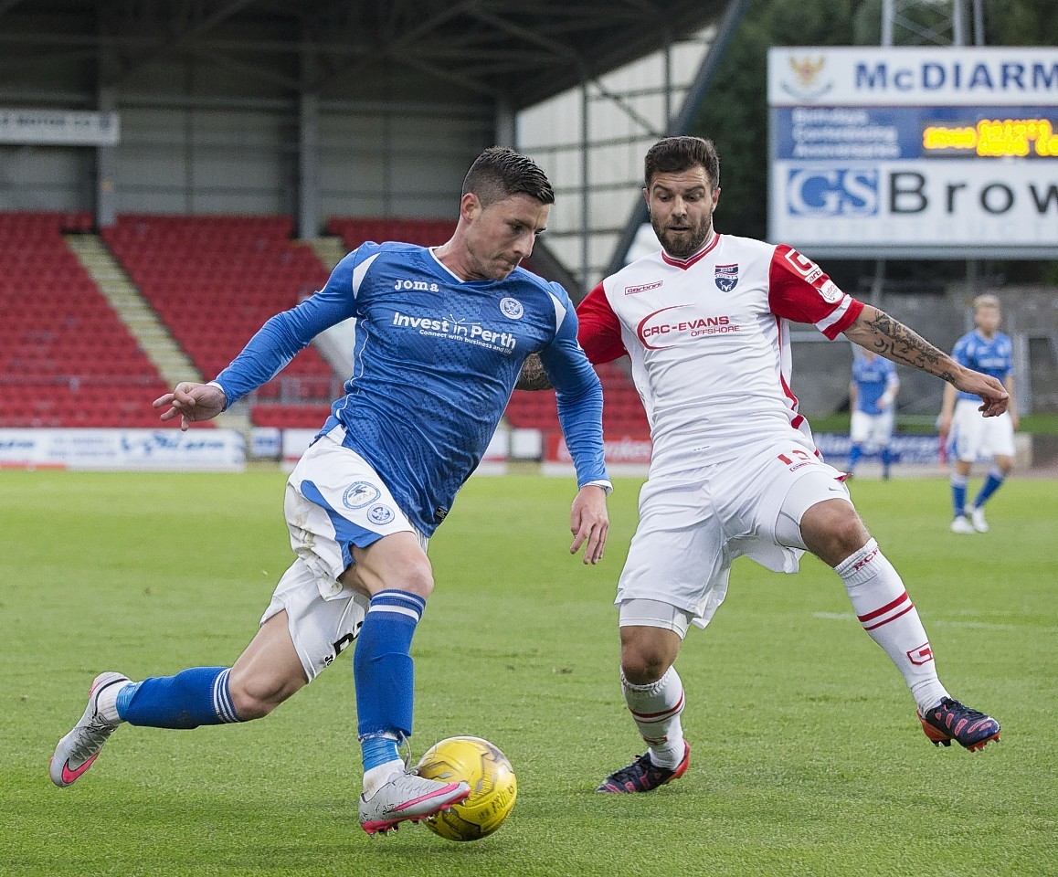 St Johnstone's Michael O'Halloran battles for the ball against Ross County's Richard Foster