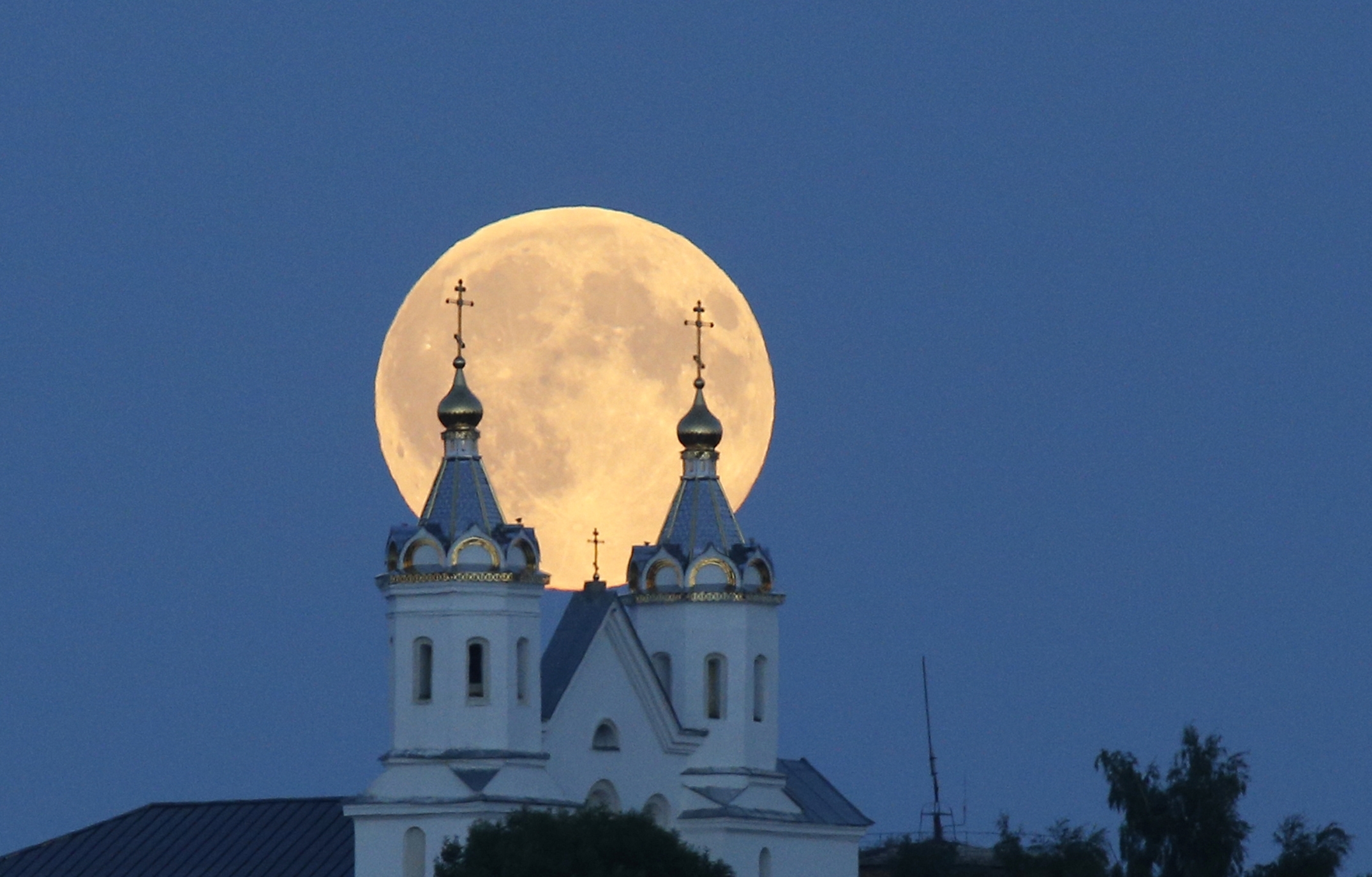 The super moon, rises above the Orthodox Church in the town of Novogrudok, 150 kilometers (93 miles) west of the capital Minsk, Belarus