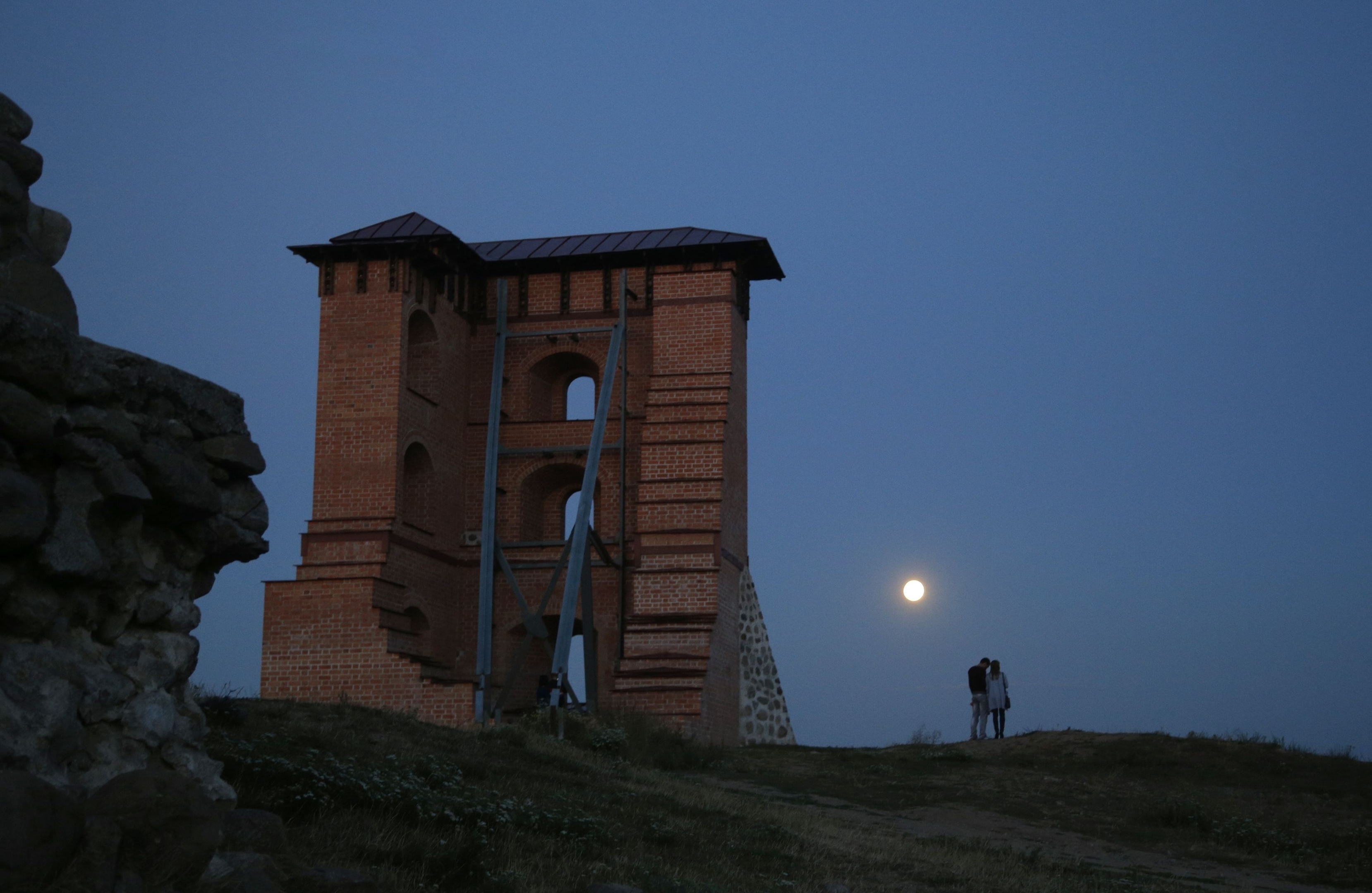 The super moon, rises above the remains of a medieval fortress in the town of Novogrudok, 