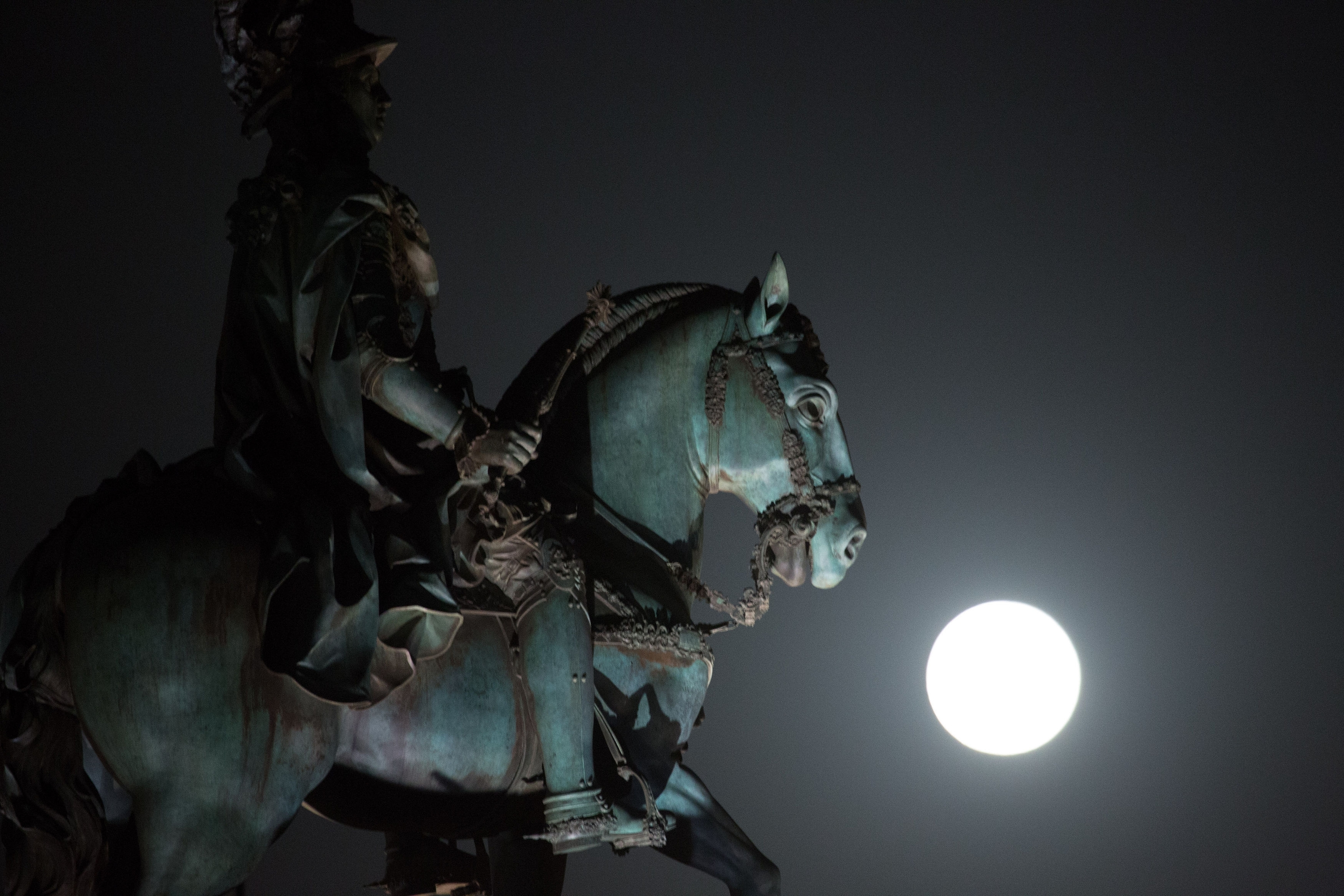 A  so-called "supermoon" full  moon rises behind the statue of Portuguese king Jose I in Lisbon's Comercio square Saturday, August 29. 