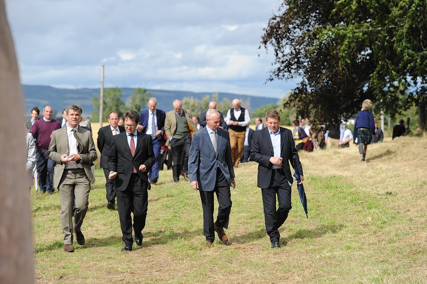 Guests walk to the new standing stones for the inauguration of the project.