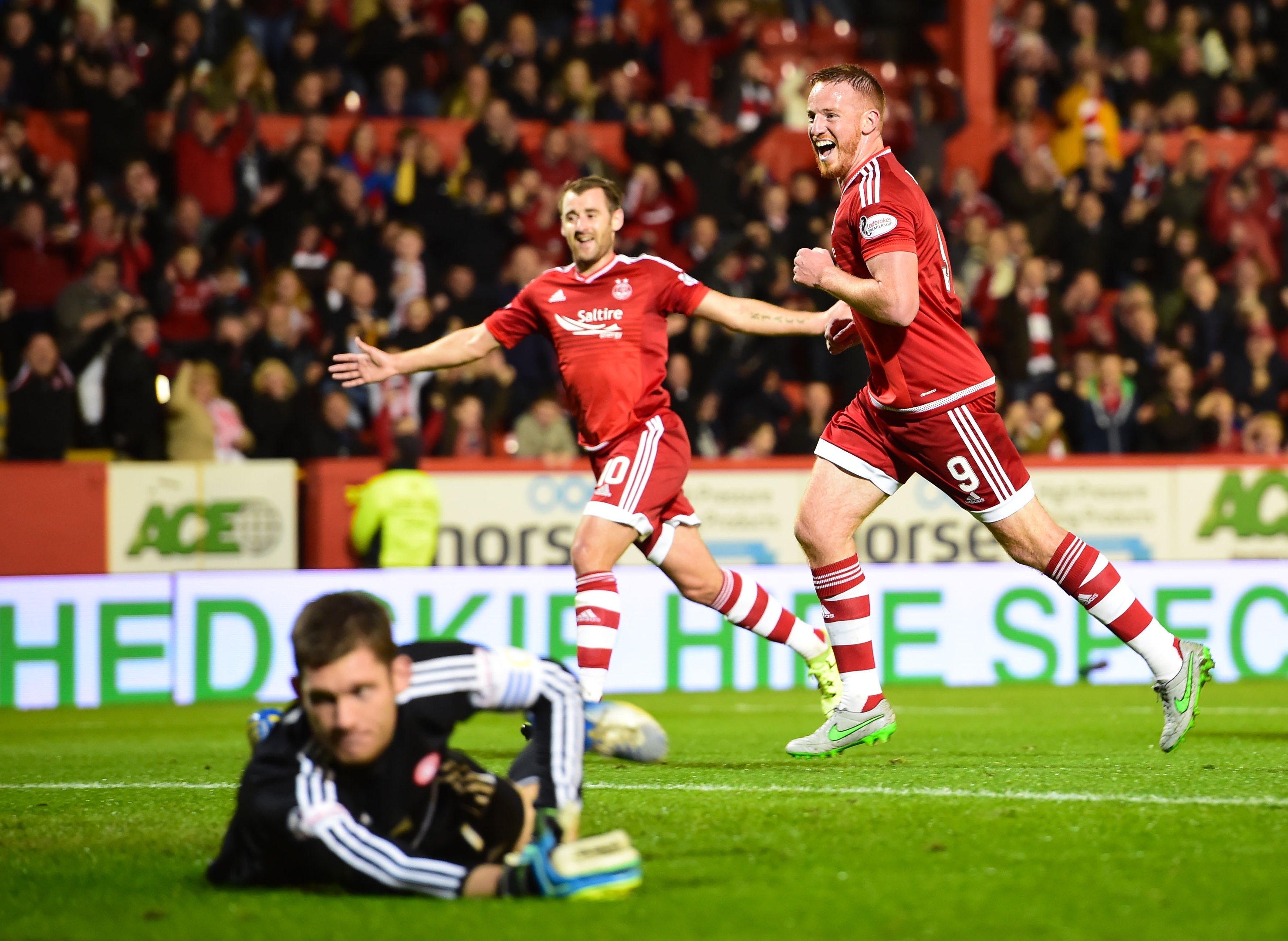Adam Rooney celebrates having fired home from the penalty spot to put his side ahead