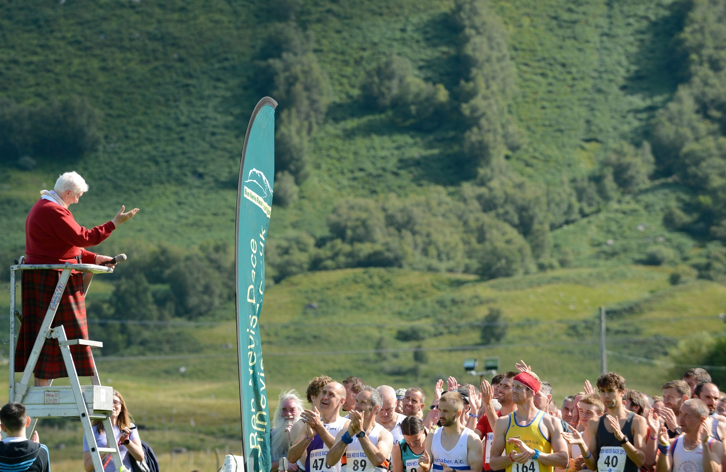 Kathleen MacPherson Takes a bow before Firing the start gun for this years Ben Nevis Runners. 60 years to the day that she was the first woman to run up and down Ben Nevis