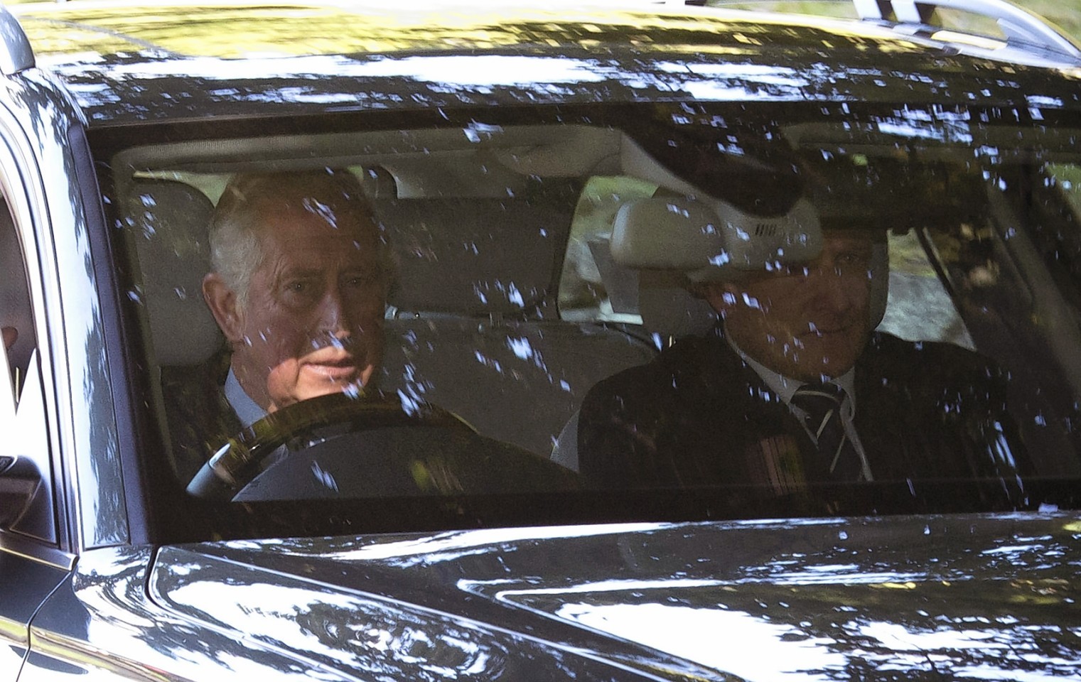 The Prince of Wales (left) arrives at Crathie Kirk 