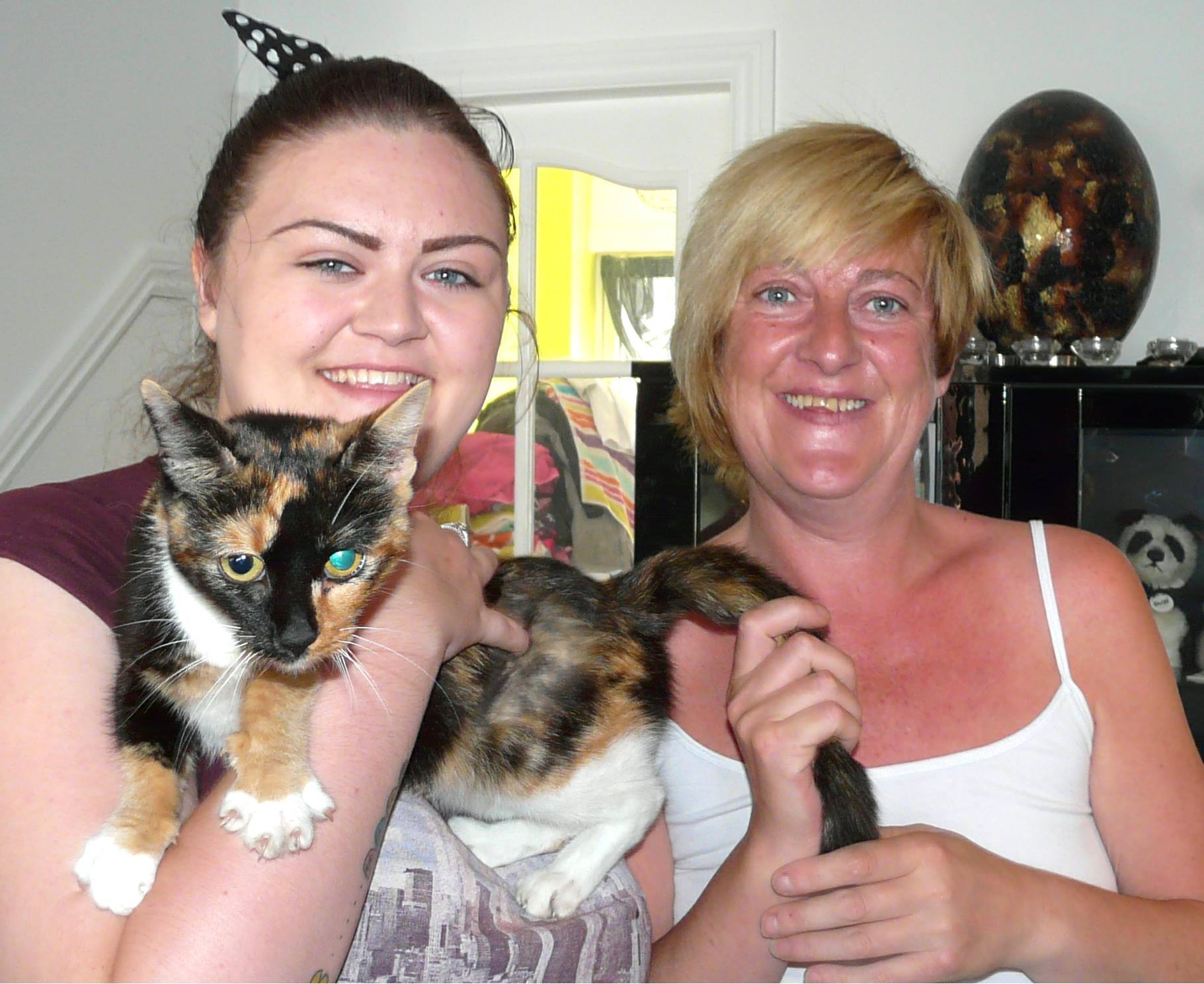 Daisy the cat with owner Mandy Watson, right